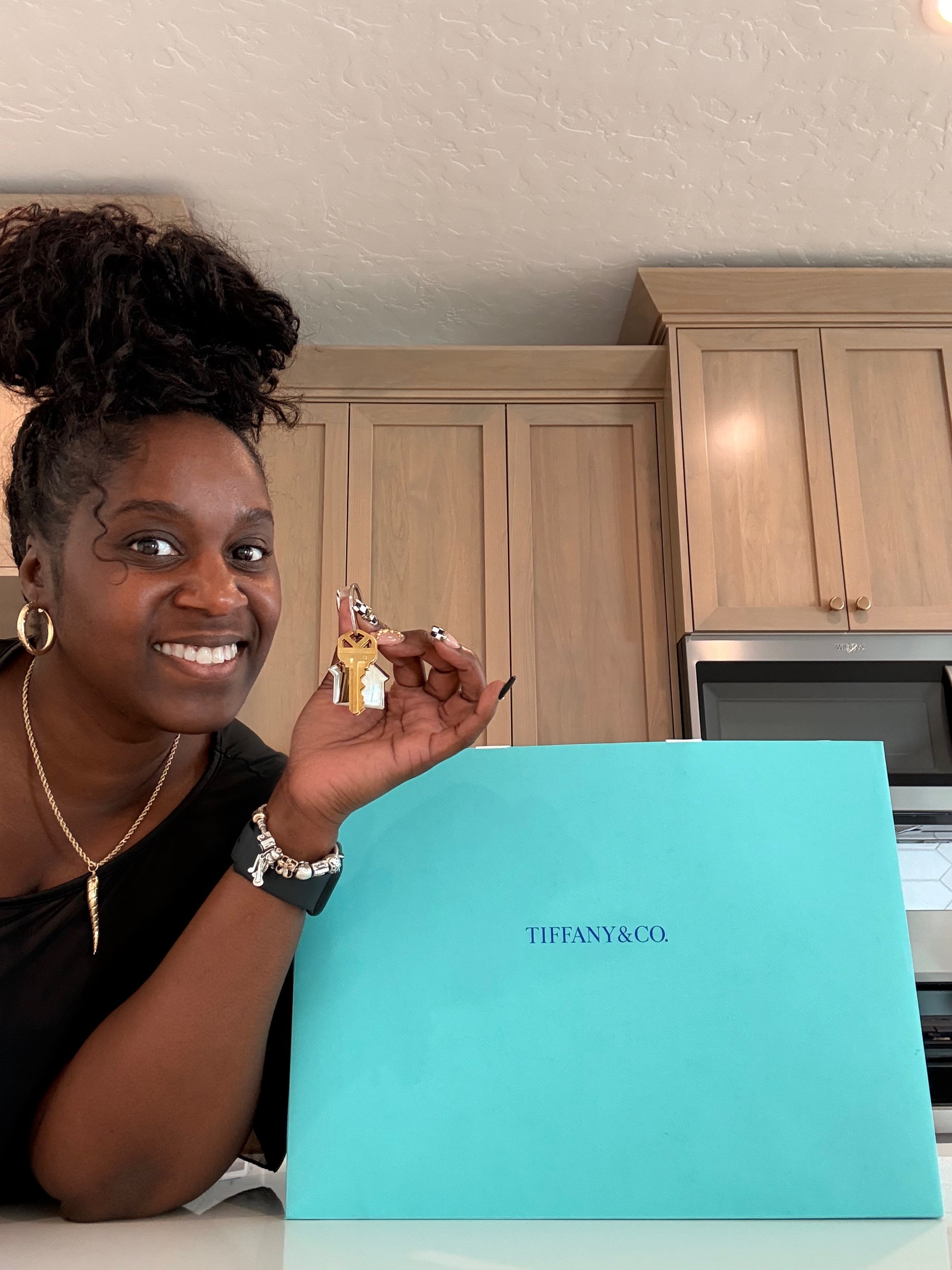 Sherika holding the keys to her first home on closing day