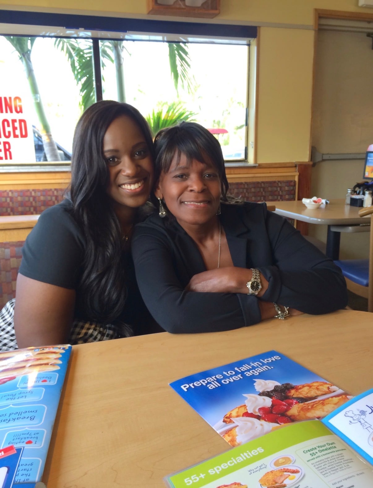 Sherika and her mother sitting together in a booth