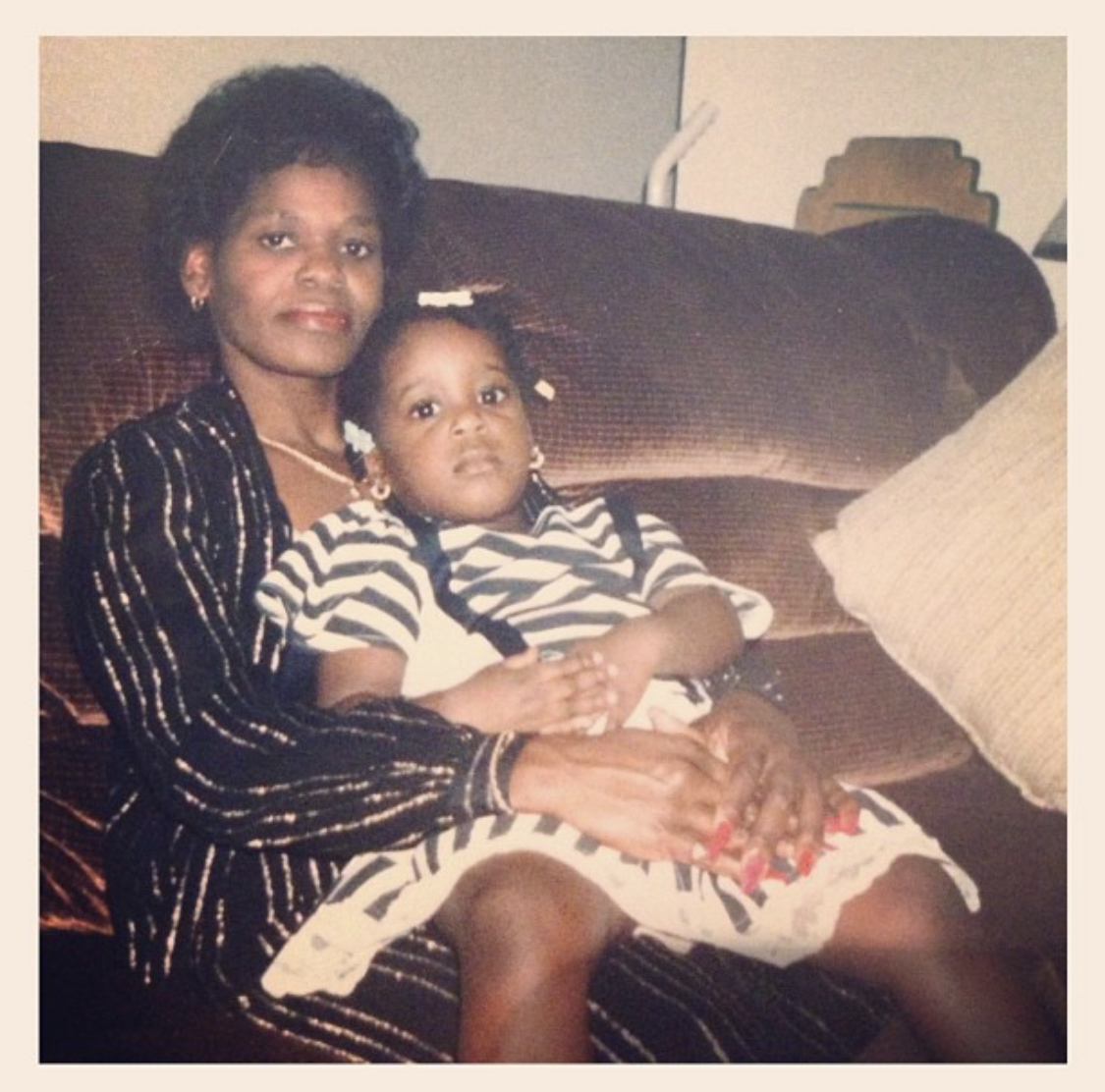 Sherika’s mother holding her as a toddler